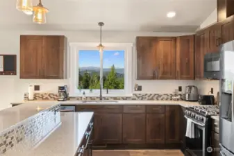 Gorgeous alder cabinets & quartz counters. You can enjoy this amazing view even washing dishes!