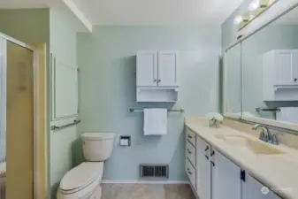 Primary bedroom bath with full length vanity and lots of cabinetry