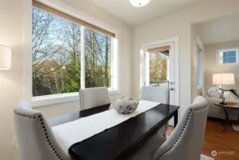 Dining room looking out to Native Growth Protection with door to balcony also overlooking native space.