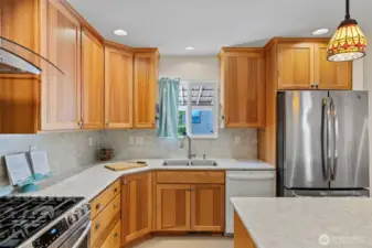 Overlooking the side yard, you will enjoy this beautifully remodeled kitchen. No stone unturned!