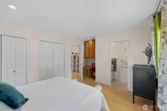 Another view of primary bedroom with  double closets, brand new half bath and built in hickory desk area