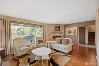 Lots of light and wood burning fireplace with brick surround