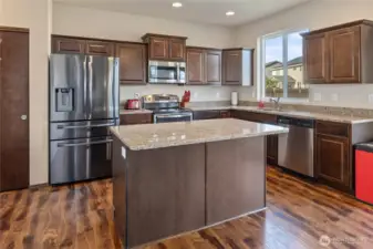 Because every party gravitates to the kitchen! With newer stainless appliances, granite counters, tons of storage (hello, pantry & under-stair closet), and room for bar stools and a breakfast table, this open-concept space connects seamlessly to the living room and backyard.