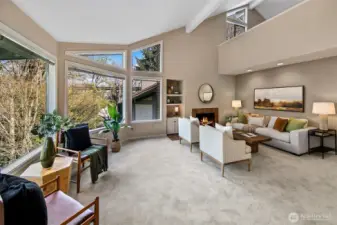Vaulted ceilings. Two bedrooms on the main floor and a primary suite upstairs.  *Photo is from when the condo was staged.