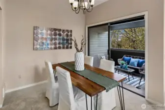 Dining room has direct access to the deck.  *Photo is from when the condo was staged.