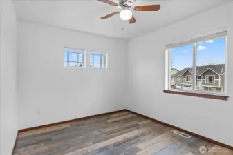 Third bedroom upstairs with ceiling fan and lots of light.