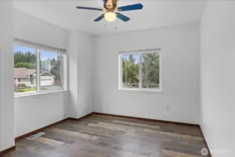 Fourth bedroom upstairs with ceiling fan.