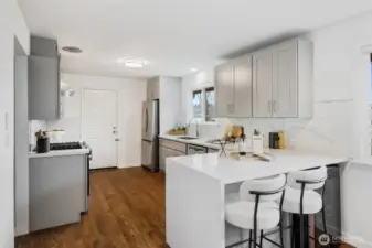 Updated kitchen with quartz counters and stainless appliances. Exterior door conveniently goes to the outside.