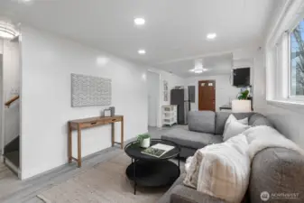 Lower level living room; west facing windows face the yard.