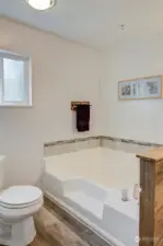 Private bath with large soaking tub off of the primary bedroom