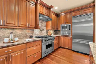 Viking appliances, gas range, pot filler, food warmer and beautiful granite slabs