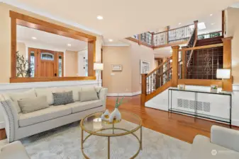 Grand entry with soaring 2-story ceiling with gorgeous iron designer railings and gleaming hardwood floor through out the main level