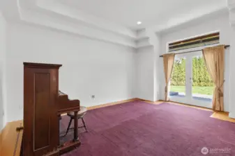 Formal living room with French door access to expansive patio and backyard.