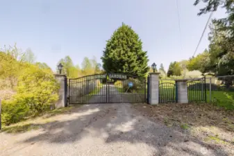 The entire property is enclosed by chain link fencing for added privacy and security, and is accessed through a  decorative gate proudly inscribed with Brinnon Gardens, named by a past owner. The decorative entry gate includes an automatic opener; however, the current access code is unknown and will need to be reconfigured by the new buyer.