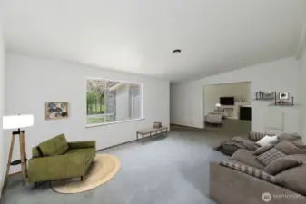 Upon entry, you're welcomed by a spacious and bright living room, anchored by a large picture window a large picture window that frames the beauty of the outdoors and fills the inviting space with natural light. This room has been virtually staged.