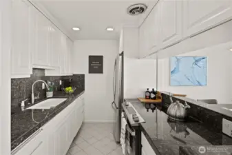 Everything is within easy reach in the kitchen with granite counter tops, new fridge and stove/oven.