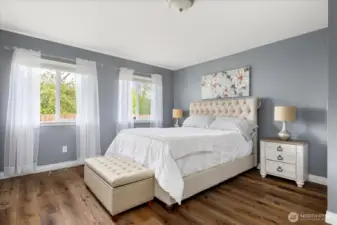 Spacious, sunlit primary bedroom conveniently located on the main floor
