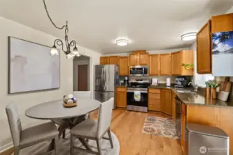 Open layout from dining to kitchen with newer appliances.