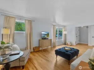 Natural light pours in through oversized windows, highlighting the craftsmanship and character throughout.