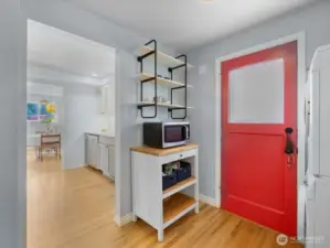 Right off the kitchen, the efficient mudroom leads to the expansive back deck and yard.