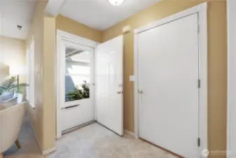 Looking back on the front door with garage access into the home.