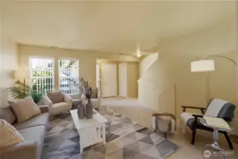 This warm and inviting living room is the perfect place to relax or entertain. Note the extra storage below the stairs.