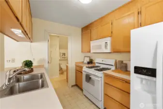 This kitchen flooring has actually been replaced with more modern floors - go see the unit in person to see how lovely they turned out! PS: Cooking with gas is the best!