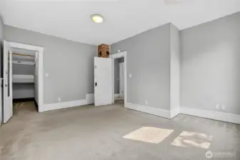 Largest upstairs bedroom from another angle, showing walk-in closet and view toward the hallway.