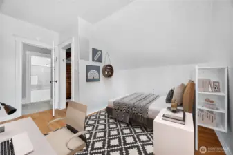 Upstairs bedroom with natural light, walk-in closet, and easy access to the full bathroom. (Virtually Staged.)