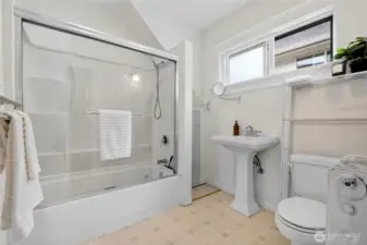 Full upstairs bathroom with natural light, conveniently accessible from all three bedrooms.