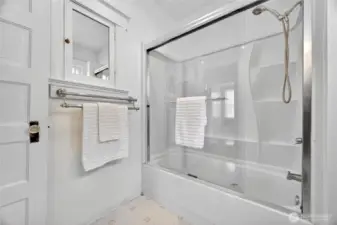 Full upstairs bathroom featuring a spacious walk-in shower and tub combination.