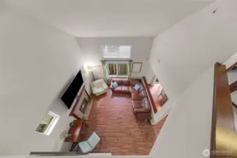 Looking down from flex space loft to living area