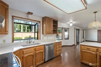 Spacious kitchen with updated quartz countertops, and stainless steel appliances. Abundant natural light.