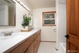 Refreshed full main bath with new double vanity, quartz tops and custom tile shower.