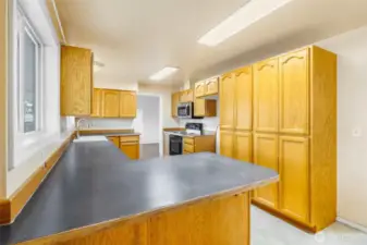 Another view of the kitchen.  Check out the massive pantry cupboards!  There's an outlet in one of them.