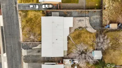 As you can see, the backyard has a wonderful shade tree, more parking, and a rock garden. The shed is handy for garden tools.