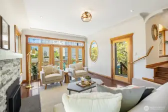 Glass front door lets in even more light and the front entrance wraps around to the deck and with stairs to the back yard as well.