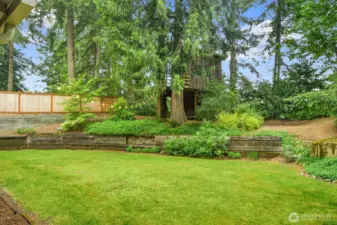 Beautiful backyard framed by lush greenery, offering privacy and a tranquil setting.