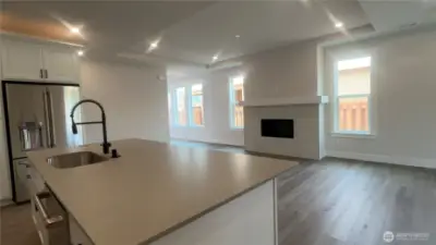 This quartz island is massive and great for entertaining. LVP throughout, FP w/mantel.