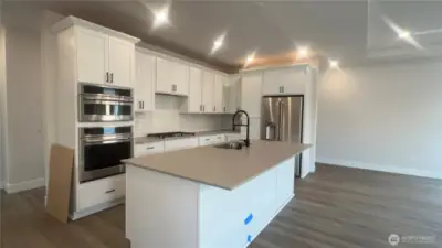 Nearing completion...  Wall Oven, Microwave, Gas Stove and Fridge all included.  Plenty of cabinet space, drawers and pantry.  Soft close cabinets