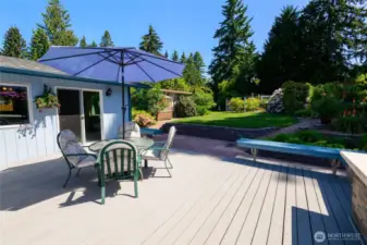 This low-maintenance Trex deck offers ample room for dining, lounging, and summer barbecues, while the adjoining patio provides a seamless extension of your living space.