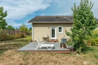 Spacious yard with nice deck, mature landscaping, garden area and greenhouse.