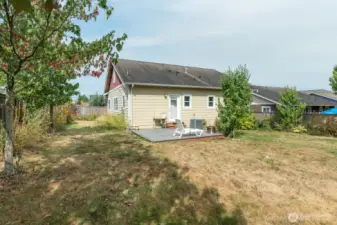 Spacious yard with nice deck, mature landscaping, garden area and greenhouse.