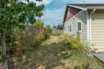 Spacious yard with nice deck, mature landscaping, garden area and greenhouse.