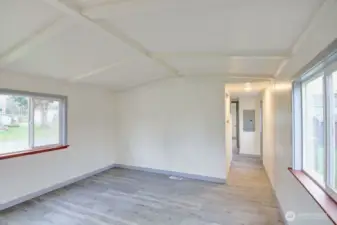 Living room and view of the hallway to the bedrooms and bathroom. There is another door to the west yard with a shed.