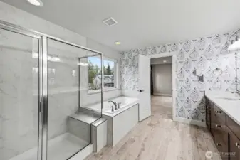 Primary en-suite with a separate water closet, dual sinks, soaking tub, and large walk-in shower.