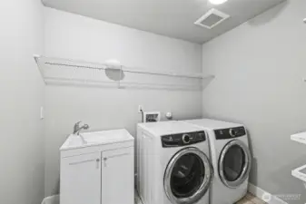 Conveniently located on the second floor is your laundry room with tons of storage space, and handwash sink.
