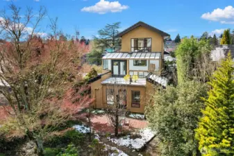 A private sanctuary—multiple decks, mature landscaping, and seamless indoor-outdoor living