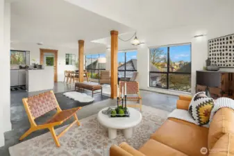 Great room with exposed timber rises from polished concrete floor