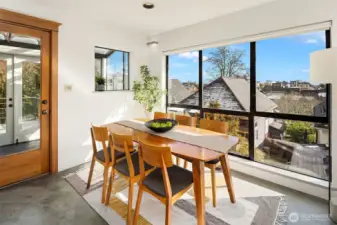 Dining area with expansive windows and direct connection to outdoor living